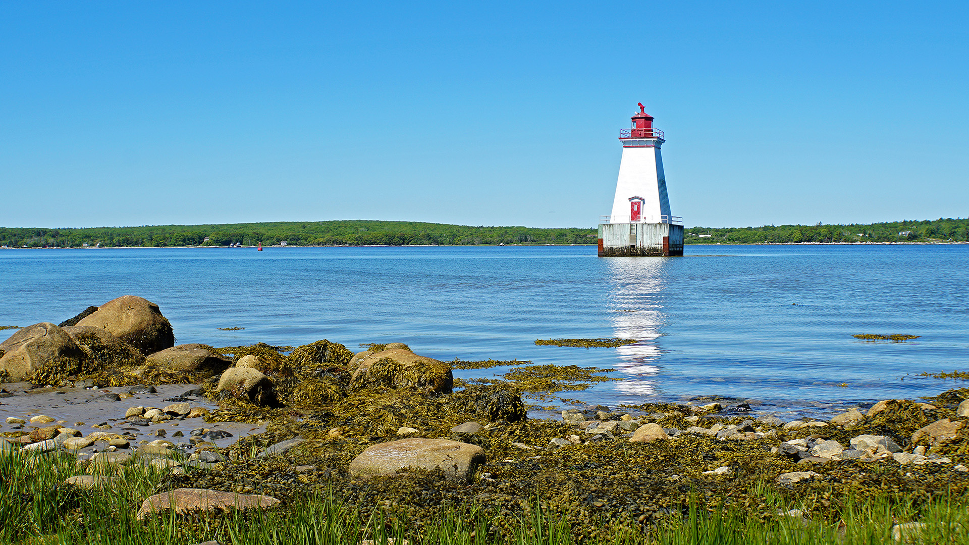 White lighthouse in middle of river