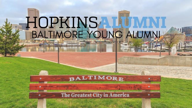 Baltimore Young Alumni with the Baltimore skyline and Bench