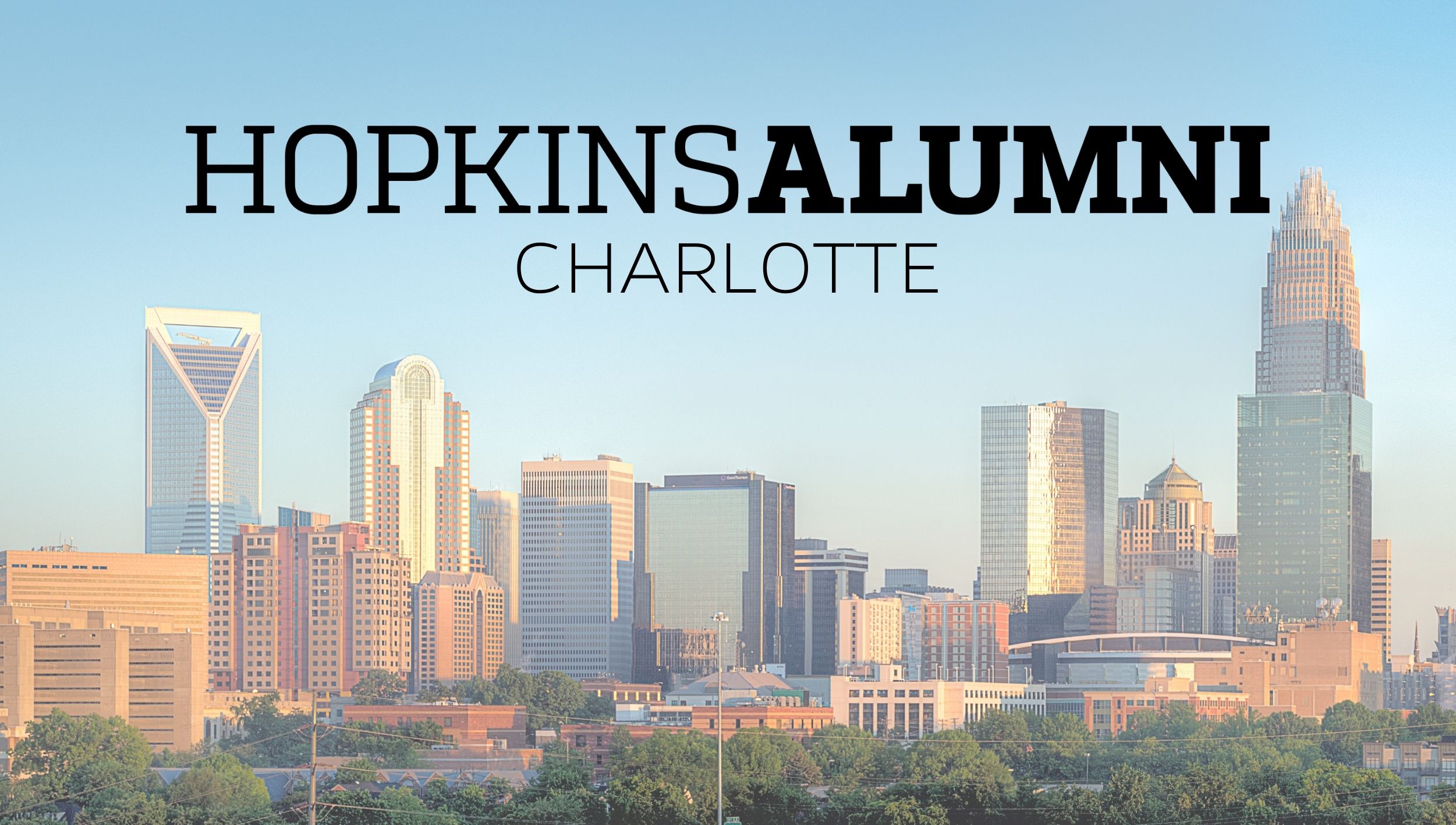 Charlotte Skyline with Hopkins Alumni Banner