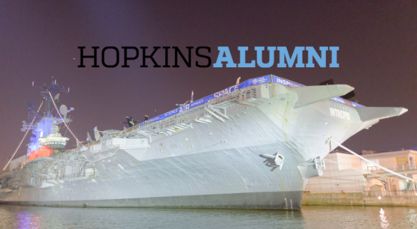 Photo of the USS Intrepid aircraft carrier with the Hopkins Alumni logo on the picture